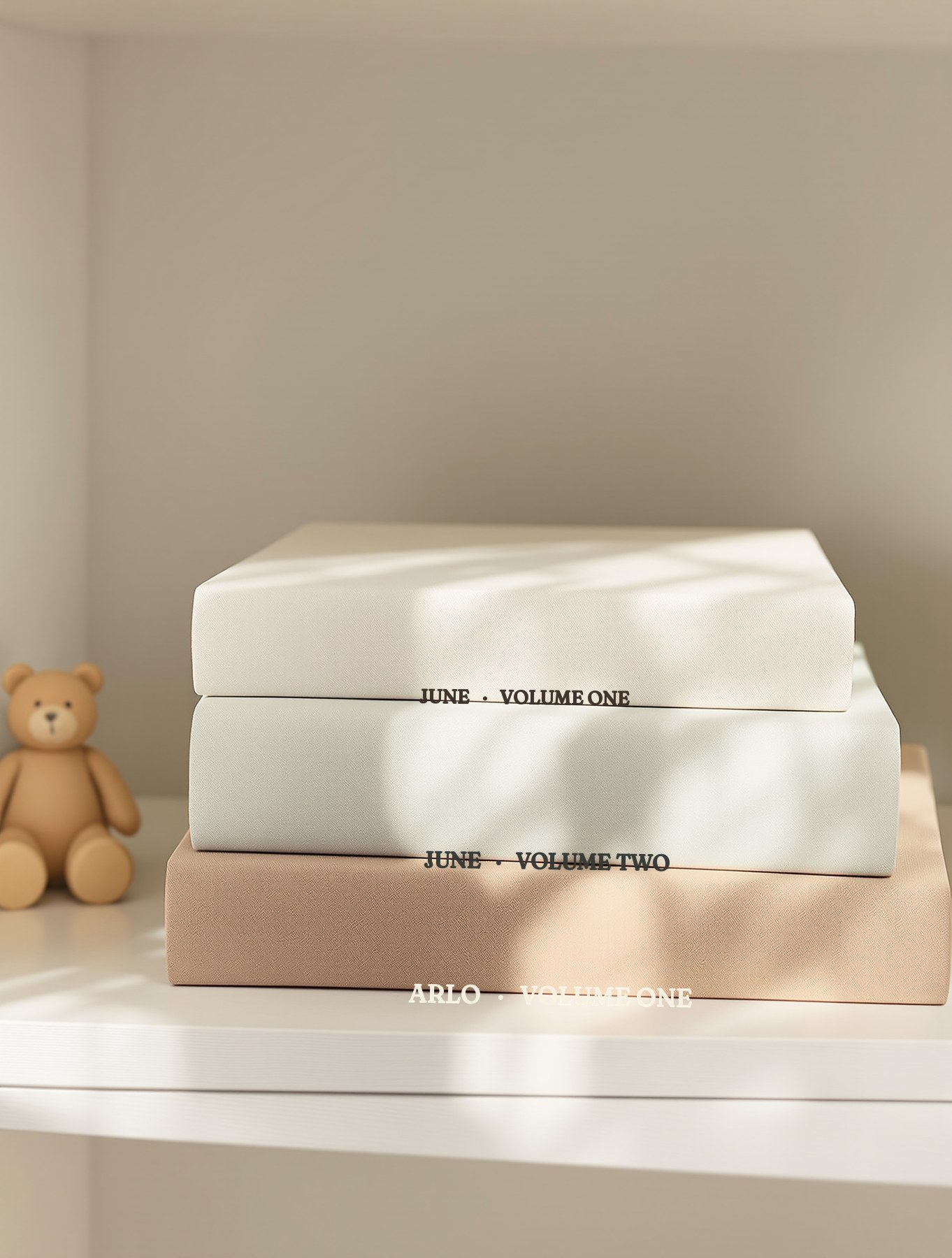 Three Volume One baby books stacked on a nursery shelf